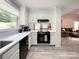 Clean kitchen with white cabinets, black appliances, and hardwood floors at 8105 Rachel Ct, Waxhaw, NC 28173