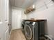 Functional laundry room with modern washer and dryer, plus countertop space at 8105 Rachel Ct, Waxhaw, NC 28173