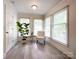 Bright sitting area with three windows, light walls, and a comfortable chair at 8105 Rachel Ct, Waxhaw, NC 28173