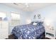 Bright bedroom with a large window and floral bedding, complemented by white furniture and dark wood floors at 8306 Knights Bridge Rd, Charlotte, NC 28210