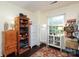 Bedroom with various storage solutions, including wooden shelves and white drawers, with natural light from the window at 8306 Knights Bridge Rd, Charlotte, NC 28210
