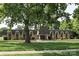 Commercial building on a landscaped lot with well-manicured lawn and mature trees, offering a professional setting at 8306 Knights Bridge Rd, Charlotte, NC 28210