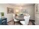 Elegant dining room with chandelier and seating for four at 8306 Knights Bridge Rd, Charlotte, NC 28210