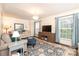 Comfortable living room featuring hardwood floors and ample natural light at 8306 Knights Bridge Rd, Charlotte, NC 28210