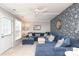 Comfortable living room featuring a large sectional sofa, a decorative accent wall, and lots of natural light at 8306 Knights Bridge Rd, Charlotte, NC 28210
