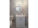 Charming powder room with decorative wallpaper, a modern vanity with a marble countertop and a unique beaded mirror at 8306 Knights Bridge Rd, Charlotte, NC 28210