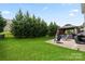 Large backyard boasts green lawn, patio with seating, grill, and gazebo, creating a perfect outdoor living space at 8347 Dallas Bay Rd, Charlotte, NC 28278