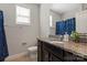 This bathroom offers a spacious vanity, matching mirror, window, and shower-tub combination at 8347 Dallas Bay Rd, Charlotte, NC 28278