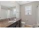 Well-lit bathroom with a granite vanity, tiled floor, window, and shower-tub combination, offering a refreshing space at 8347 Dallas Bay Rd, Charlotte, NC 28278