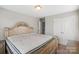 Spacious bedroom featuring a large bed, neutral walls, and double door closet, providing a comfortable retreat at 8347 Dallas Bay Rd, Charlotte, NC 28278