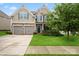 Charming two-story home featuring a well-manicured lawn, a two car garage and stone accents at 8347 Dallas Bay Rd, Charlotte, NC 28278