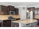 Well-equipped kitchen featuring granite counters, stainless appliances, and dark wood cabinets at 8347 Dallas Bay Rd, Charlotte, NC 28278