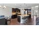 Modern kitchen with granite countertops, stainless steel appliances, dark wood cabinetry and seating for three at 8347 Dallas Bay Rd, Charlotte, NC 28278