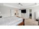 Bright main bedroom with tray ceiling, ceiling fan, and access to en-suite bath and walk-in closet at 8347 Dallas Bay Rd, Charlotte, NC 28278
