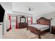 Spacious main bedroom with tray ceiling, carpet, ceiling fan and large bed with modern decor at 8347 Dallas Bay Rd, Charlotte, NC 28278