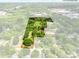 Aerial view showcasing the approximate lot lines of a spacious and heavily wooded property at 84 Sumner Nw Ave, Concord, NC 28027