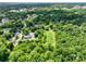 High-angle shot revealing a leafy suburban area with residential streets and verdant trees at 84 Sumner Nw Ave, Concord, NC 28027
