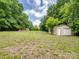 The backyard has a metal storage building with a roll-up door at 84 Sumner Nw Ave, Concord, NC 28027