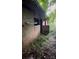 Exterior view of a property with weathered walls and overgrown vegetation at 84 Sumner Nw Ave, Concord, NC 28027
