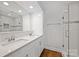 Modern bathroom with a double sink vanity, large mirror, and a tiled glass-door shower at 901 Scaleybark Rd, Charlotte, NC 28209