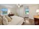 Bright bedroom featuring hardwood floors, a vintage dresser, and large white closets at 901 Scaleybark Rd, Charlotte, NC 28209