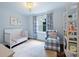 Charming Bedroom with a crib, patterned curtains, and stylish lighting at 901 Scaleybark Rd, Charlotte, NC 28209