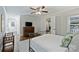 Bedroom with hardwood floors, and a ceiling fan, with an open door to a hall and white exterior door at 901 Scaleybark Rd, Charlotte, NC 28209