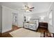 Bright bedroom featuring a ceiling fan, hardwood floors, and natural light from the windows at 901 Scaleybark Rd, Charlotte, NC 28209