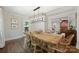 Bright dining room with hardwood floors features contemporary light fixture and flows into living spaces at 901 Scaleybark Rd, Charlotte, NC 28209