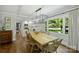 Bright dining room with large window features hardwood floors and a contemporary chandelier over a wooden table at 901 Scaleybark Rd, Charlotte, NC 28209
