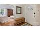 Foyer features hardwood floors, a decorative wooden chest, and a mirror above at 901 Scaleybark Rd, Charlotte, NC 28209