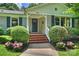 Inviting front entrance with brick steps, manicured bushes, and beautiful pink flowers at 901 Scaleybark Rd, Charlotte, NC 28209