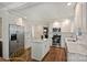 Bright kitchen features white cabinets, stainless steel appliances, and an island with a marble countertop at 901 Scaleybark Rd, Charlotte, NC 28209