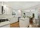 Modern white kitchen featuring sleek countertops, stainless steel appliances, and open dining area at 901 Scaleybark Rd, Charlotte, NC 28209
