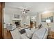 Bright living room with fireplace features neutral furniture, hardwood floors, and flows to other spaces at 901 Scaleybark Rd, Charlotte, NC 28209
