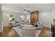 Cozy living room with hardwood floors, neutral furniture, and an antique wooden armoire at 901 Scaleybark Rd, Charlotte, NC 28209