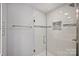 A glass shower with a tile inset shelf on the back wall and rain shower head above at 901 Scaleybark Rd, Charlotte, NC 28209