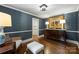 Charming blue sitting room with dark wood furniture and elegant design at 901 Scaleybark Rd, Charlotte, NC 28209