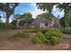 A view of the backyard with mature trees, bushes, and landscaping at 9625-A Surface Hill Rd, Mint Hill, NC 28227