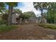 A view of the backyard with mature trees and landscaping at 9625-A Surface Hill Rd, Mint Hill, NC 28227