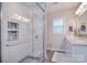 Bright bathroom featuring a glass shower, a double vanity, and modern fixtures at 9625 Surface Hill Rd, Mint Hill, NC 28227