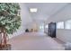 Large bonus room with neutral carpet, lots of lighting, and built in storage at 9625 Surface Hill Rd, Mint Hill, NC 28227