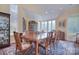 Bright dining room with a large table, china cabinet, and multiple windows providing natural light and scenic views at 9625 Surface Hill Rd, Mint Hill, NC 28227