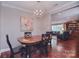 Classic dining room features modern chandelier and hardwood flooring at 9625-A Surface Hill Rd, Mint Hill, NC 28227