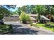 Inviting home exterior featuring mature landscaping, a circular driveway and multiple car garage at 9625-A Surface Hill Rd, Mint Hill, NC 28227