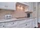 Well appointed kitchen with granite countertops, herringbone backsplash, and modern white cabinetry at 9625 Surface Hill Rd, Mint Hill, NC 28227
