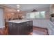 Bright kitchen boasts a large island with granite countertop, modern appliances, and hardwood flooring at 9625 Surface Hill Rd, Mint Hill, NC 28227
