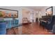 Comfortable living room featuring tile flooring, an upright piano, and blue sofas, creating a relaxing atmosphere at 9625 Surface Hill Rd, Mint Hill, NC 28227