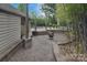 Stone patio with a fire pit and deck, offering a cozy outdoor space for entertaining and relaxation at 9625 Surface Hill Rd, Mint Hill, NC 28227