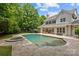 A large pool, hot tub and plenty of trees in the backyard of a large house at 9831 Sedgefield Dr, Waxhaw, NC 28173